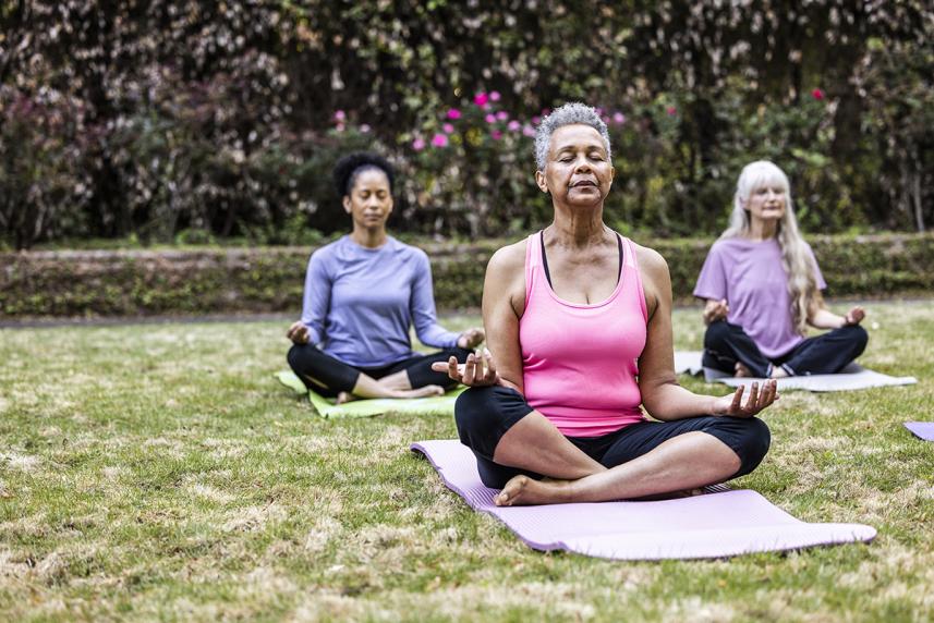 Senior woman doing yoga in the park