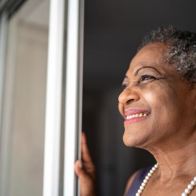 Smiling senior woman looking out the window