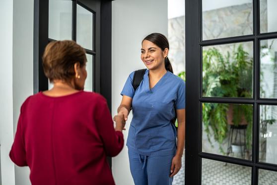 Woman welcoming a nurse for in-home assessment